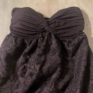 Black sweetheart mini dress with lace body and adjustable tie in back.